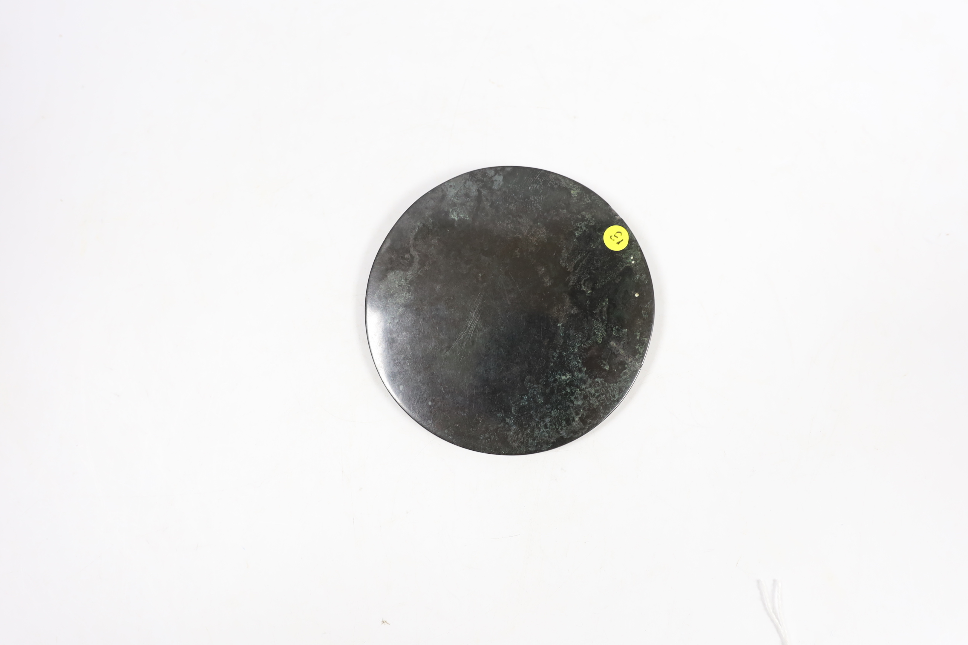 A Chinese bronze mirror, Han dynasty, 9cm in diameter